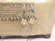 Silver dangle earring with tan flower accent
